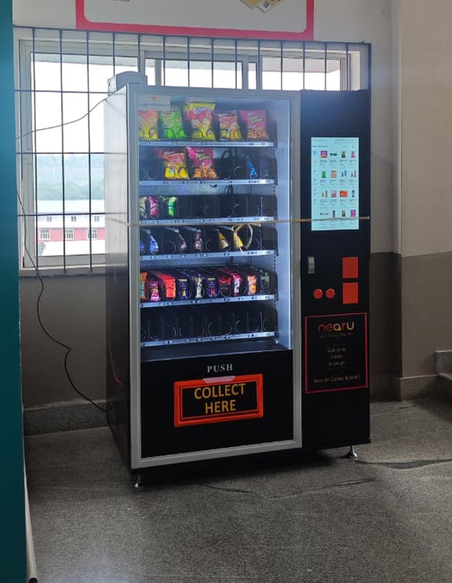NearU vending machine stocked with snacks in a college academic block in Kerala